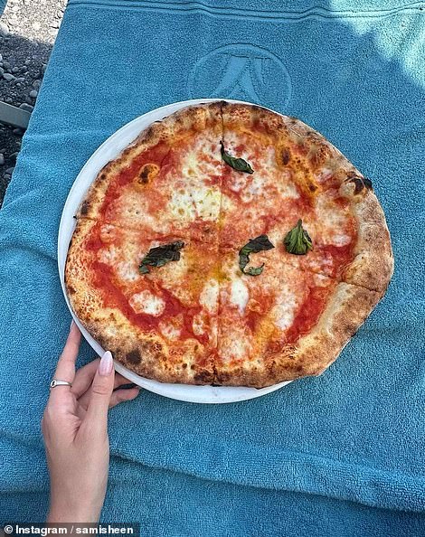 Sami indulged in cheese pizza with basil on top.