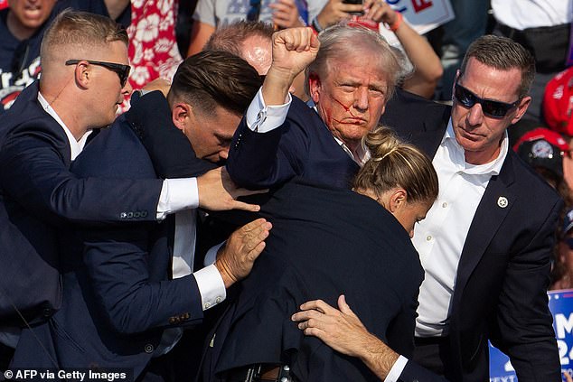 Donald Trump is seen with blood on his face after 20-year-old Thomas Crooks opened fire on the former president while he gave a speech at a rally