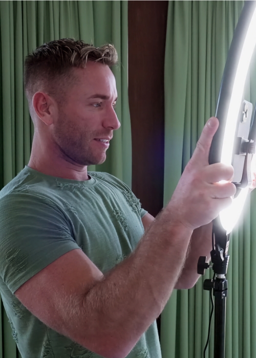 A person adjusts a ring light