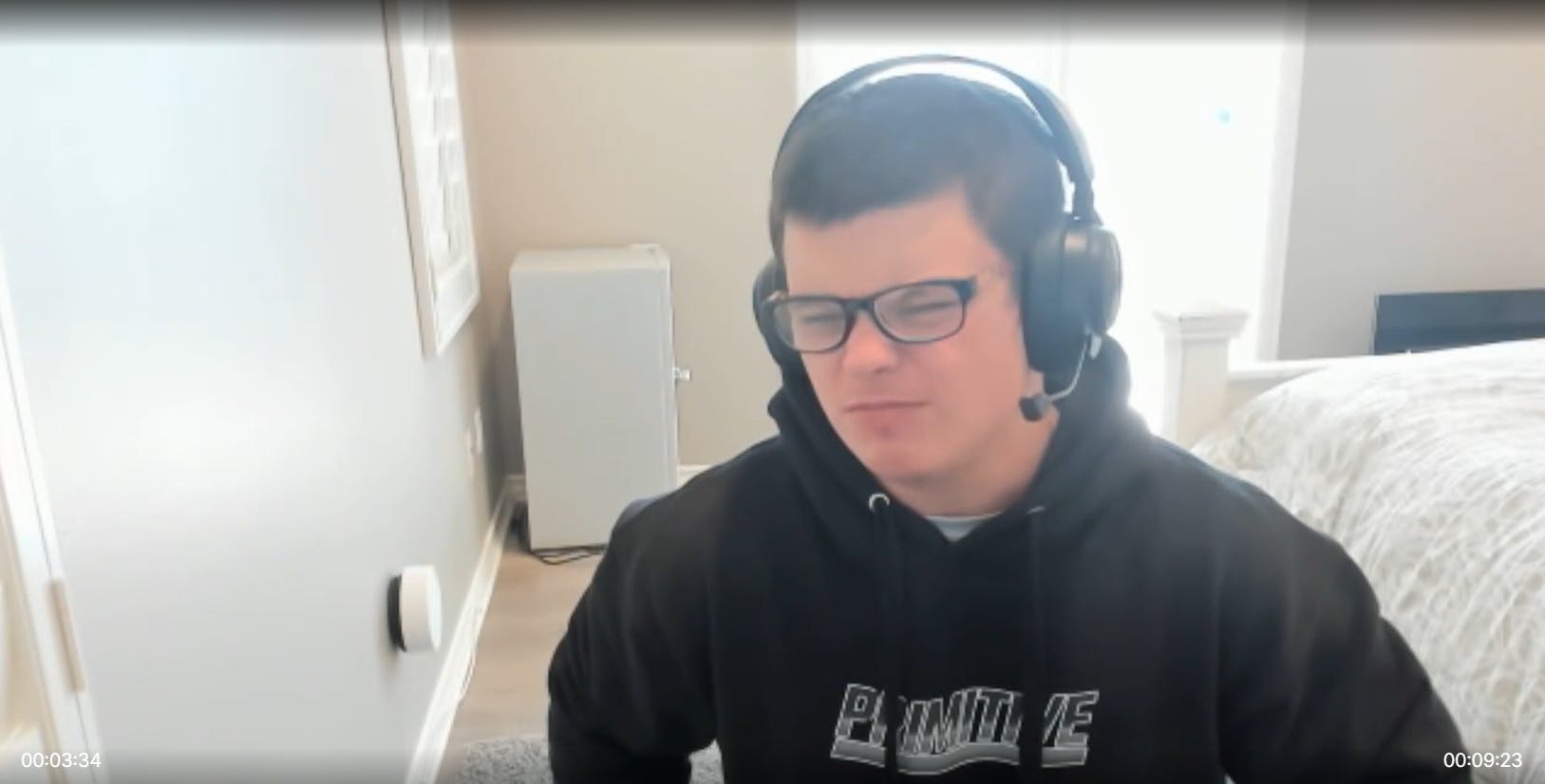 Screenshot of streamer Sketch squinting at the camera uncomfortably. He is wearing thick glasses and a black hoodie.