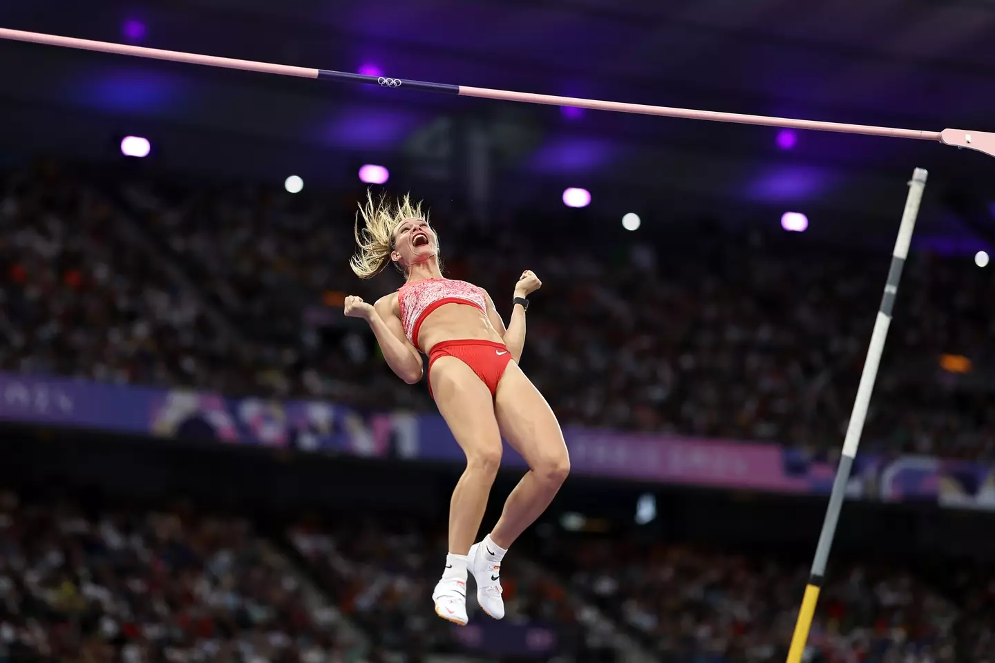 Newman celebrates as she makes it over the bar. (Cameron Spencer/Getty Images)