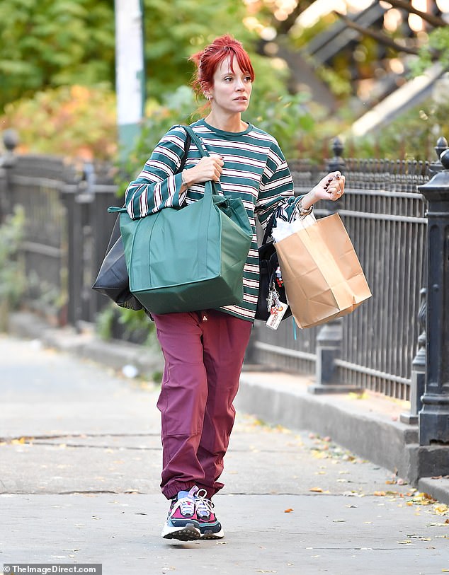 The star was laden with bags as she made her way home, carrying a large green and a black tote bag as well as a brown paper bag, going make-up free for her day of errands