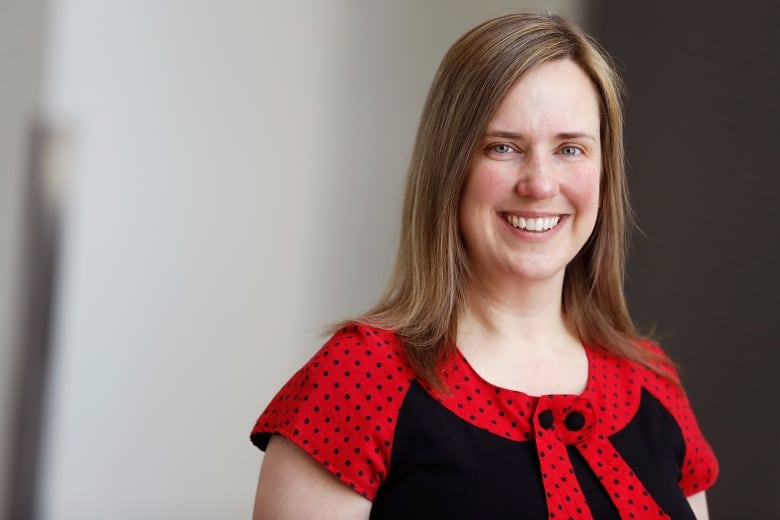 A woman wearing a black and red shirt. 