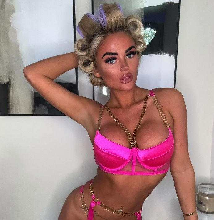 Woman in pink lingerie and hair rollers.