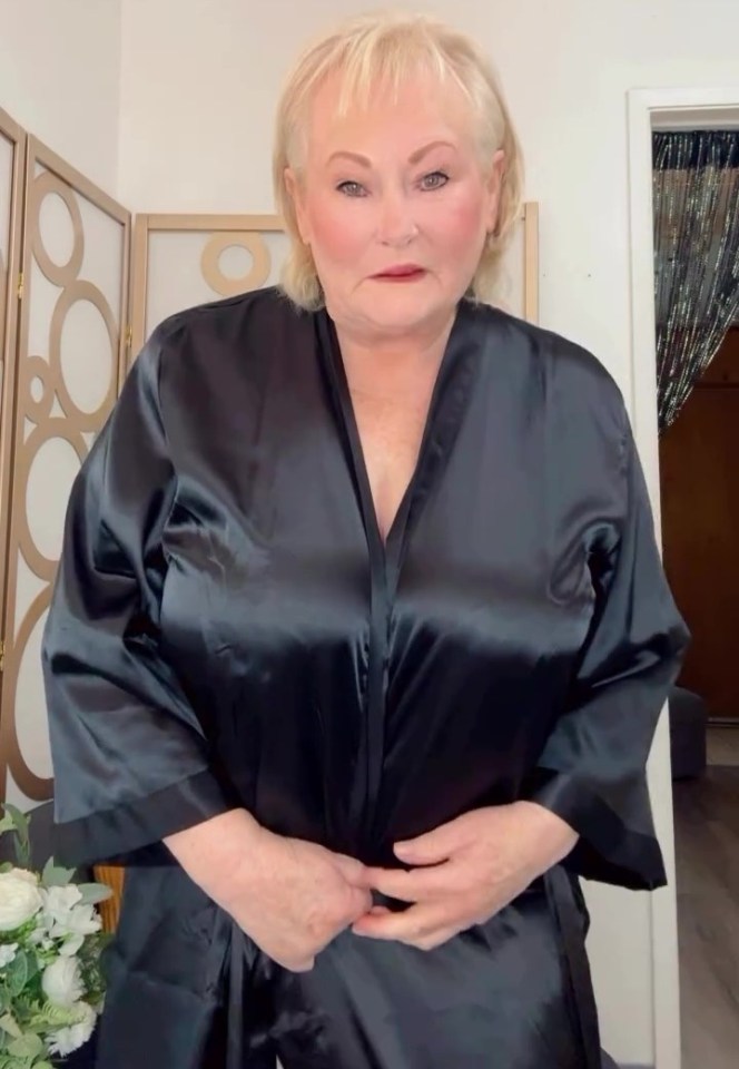 Woman in black satin robe.