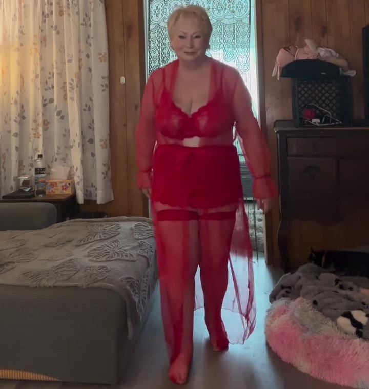 Older woman in red lingerie and robe.