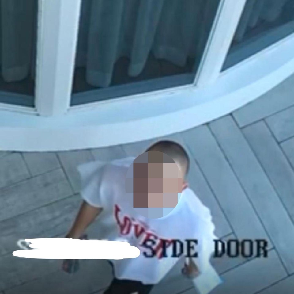 CCTV image of a person near a broken patio door.