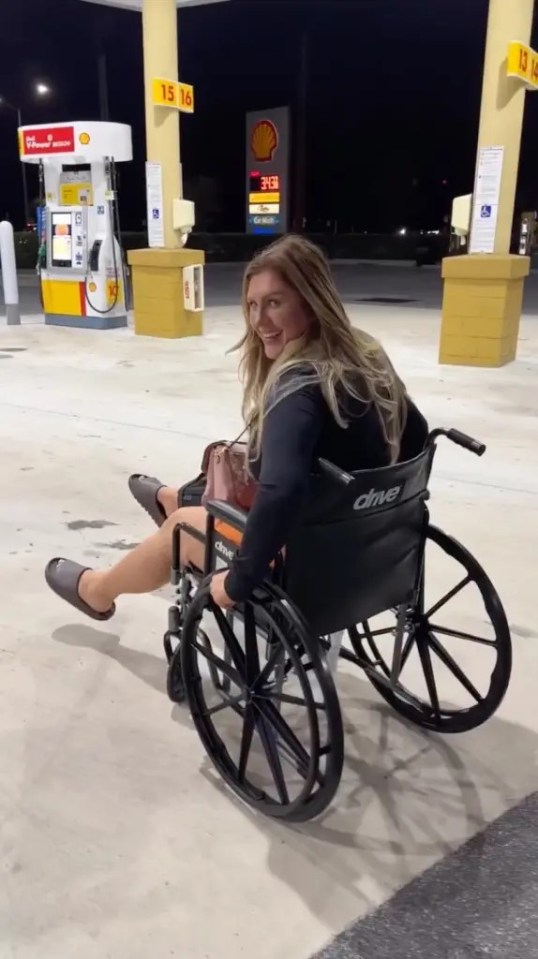 Woman in wheelchair at gas station.