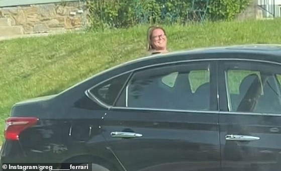 The clip ends with the woman casually walking back to her vehicle, grinning away