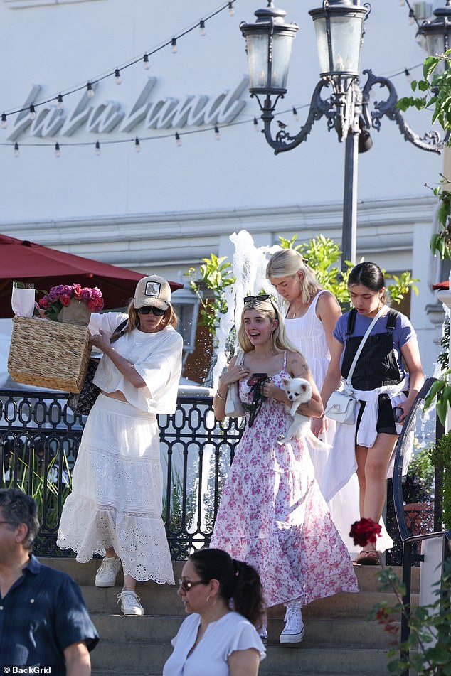 Sami, 21, paired her floral dress with understated, natural makeup and silver hoop earrings, as well as white high-top sneakers